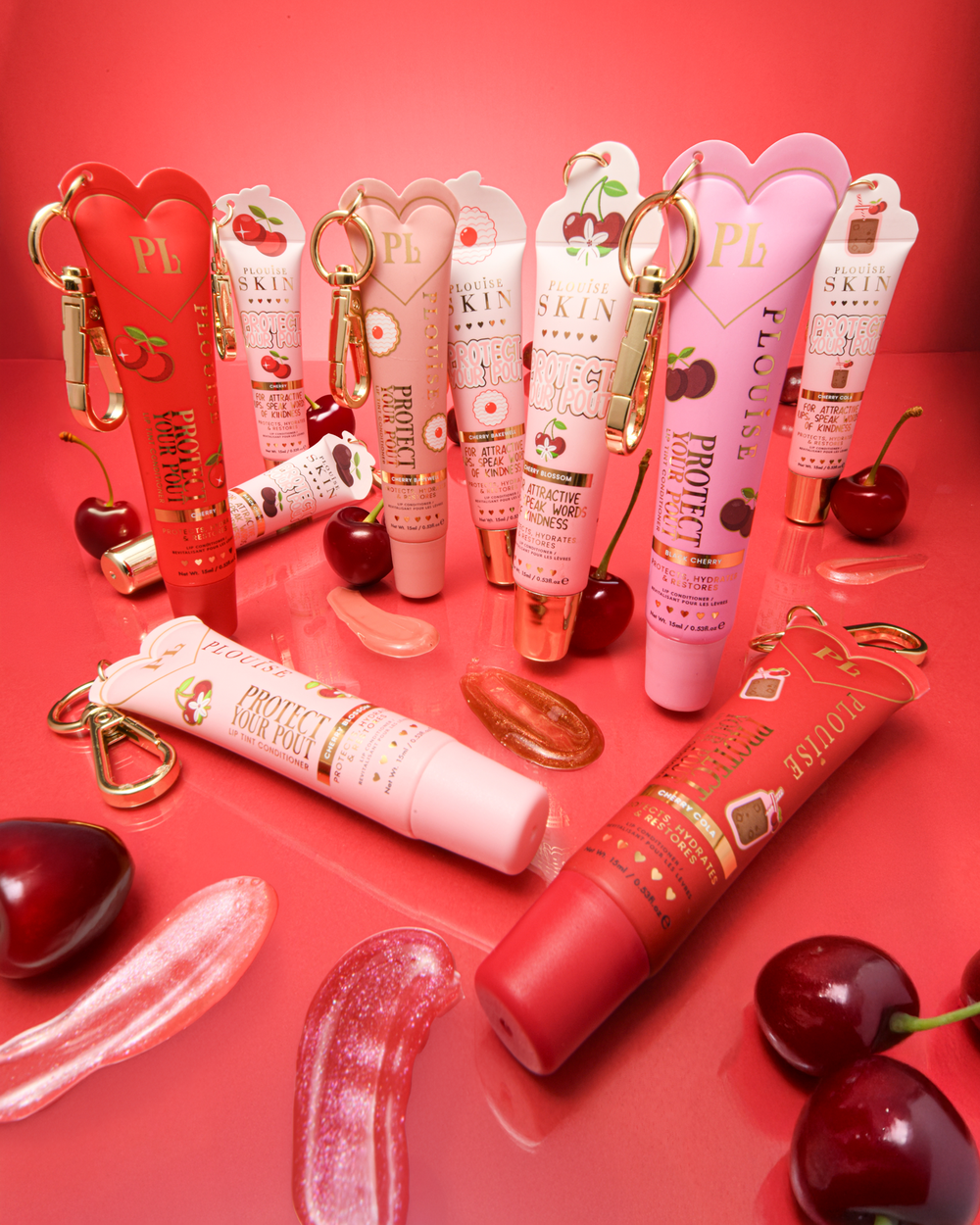 Collection of pink and red cherry protect your pout lip conditioners with swatches and cherries placed around them against a red background