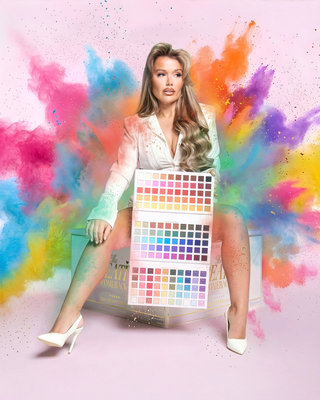 Paige holding the P.Louise Creative Comeback XXXL Rainbow Eyeshadow Palette with colour splats behind her