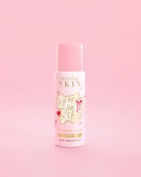 Pink P.Louise bottle of Dewing The Most Double Layer Toner with red bow designs against a pink background
