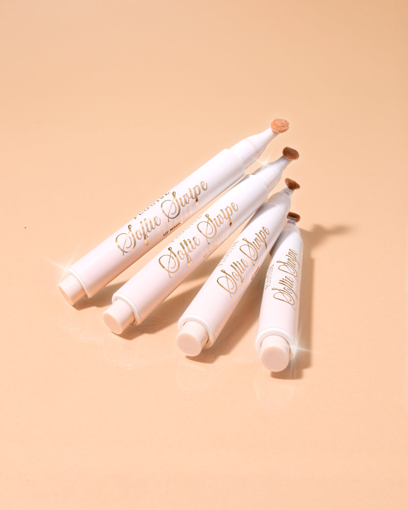 Ein Bild von vier P.Louise Softie Swipe Tinted Lip Masks mit Kokosnusskuchen-Duft, übereinander gestapelt mit beigem Hintergrund
